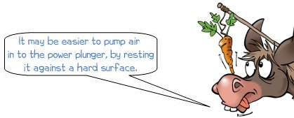 It may be easier to pump air in to the power plunger, by resting it against  a hard surface.
