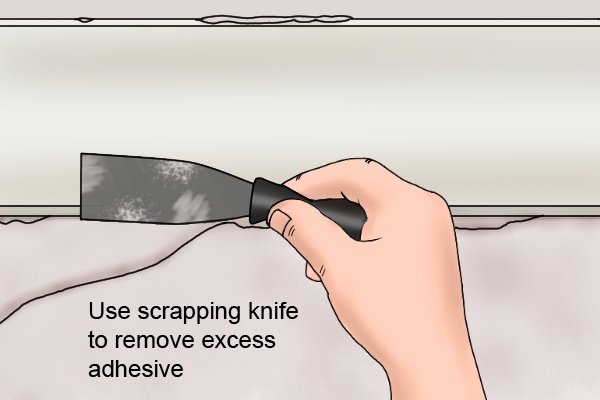 Use a scrapping knife to remove excess adhesive