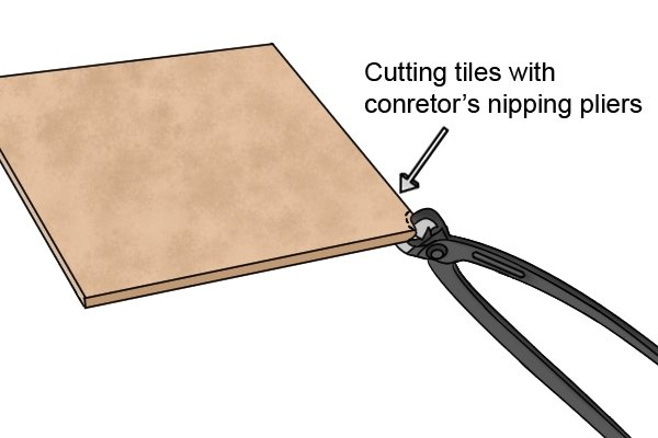 Cutting a tile with concretor's nippers