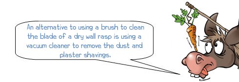 Wonkee Donkee says: "An alternative to using a brush to clean the blade of a dry wall rasp is using a  vacuum cleaner to remove the dust and  plaster shavings."