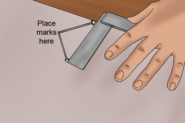 Using a marking knife place a mark at the base of the board on the outside edge of the squares blade, and another mark at the end of the blades outside edge.