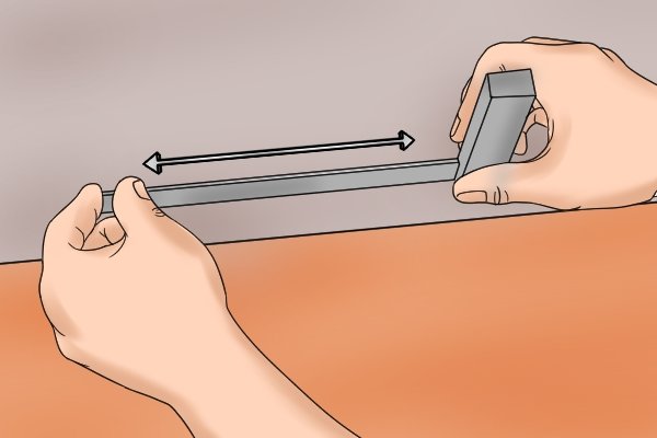 To correct the outer edge on the blade of your engineers square. Rub the outer edge of the blade on the emery cloth you have fixed to the float glass