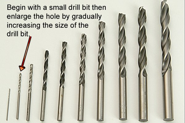 Drill bit set of progressively larger bits. These are needed to gradually enlarge a hole drilled in metal by a hand drill.
