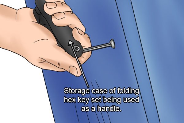 Storage case of a folding hex key set being used as a handle to give greater leverage to turn the fastener