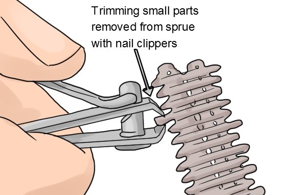 Using nail clippers instead of a sprue cutter to trim down parts removed from a sprue.
