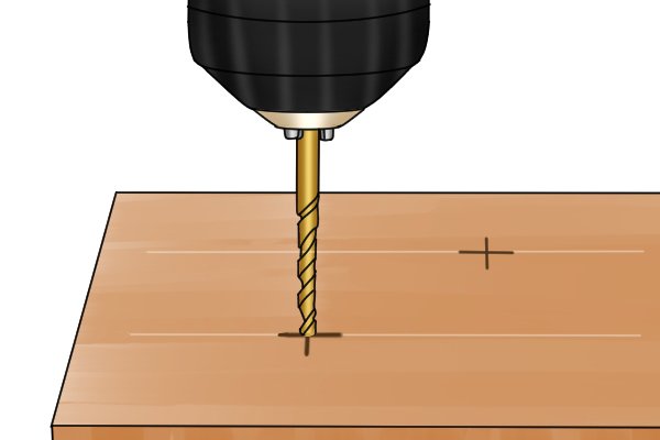 Drill and drill bit drilling a pilot hole on a pencil cross