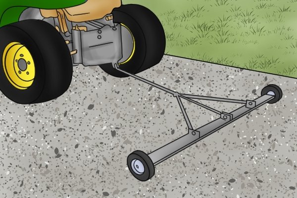 Using a trailer magnetic sweeper over gravel, being pulled by a sit down lawn mower