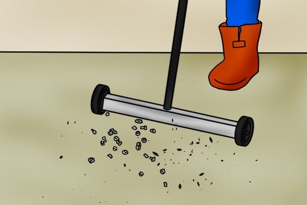 push magnetic sweeper picking up spilled bolts from a floor