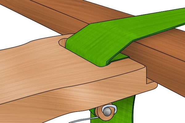 Close up of a slotted web stretcher with ridge placed against furniture to stretch out webbing