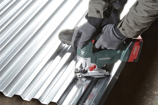 Powerful cordless jigsaw being used to cut metal