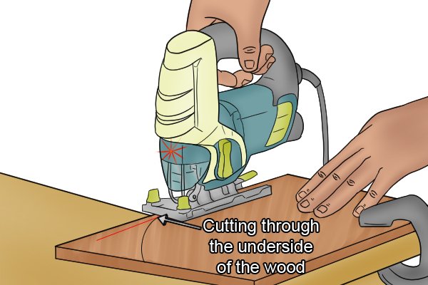 Cutting through the underside of a wooden workpiece with a jigsaw, using laser guide function of jigsaw, cutting wood with jigsaw