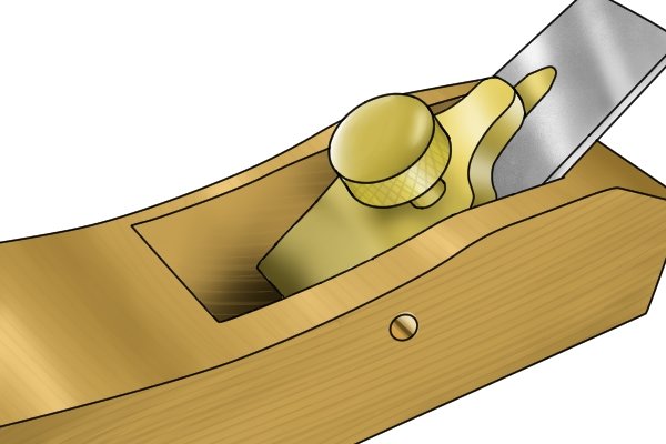 Metal lever cap on wooden bench plane