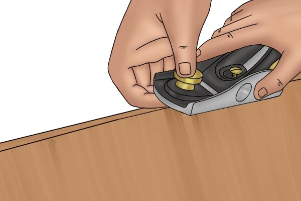 Planing a chamfer with a metal block plane