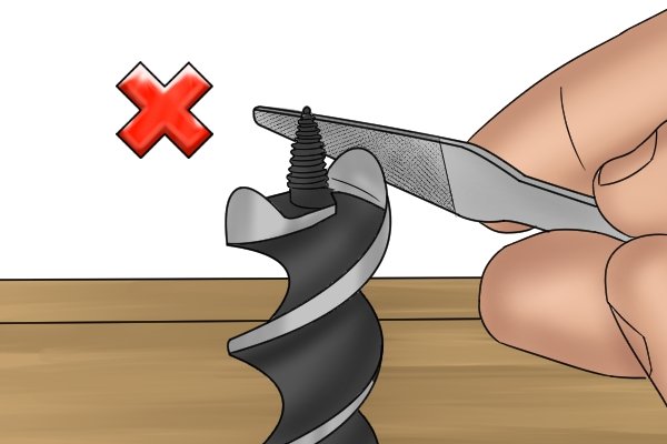 Image showing a DIYer sharpening the wrong part of an auger bit