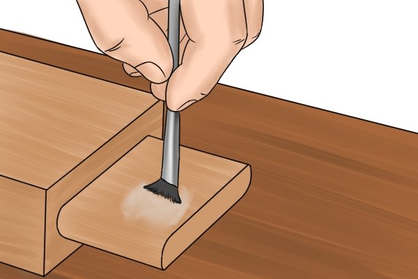 DIYer applying wood glue to a tenon