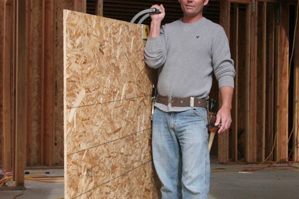 Hold the gripper type of door or board carrier over you shoulder to carry