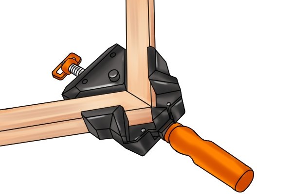AN angle clamp holding two pieces of wood for a mitre joint