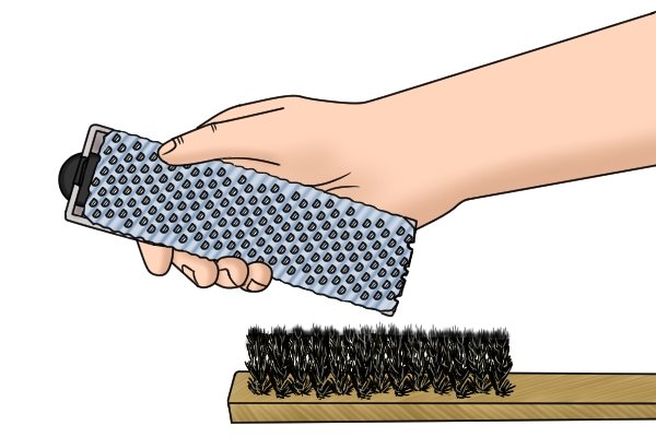 Use a fine wire brush to clean a surform blade