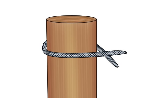 Looping wire round wooden fence post