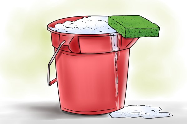 Bucket with soap suds and cleaning sponge