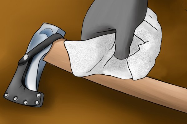 Image of a DIYer caring for their tool handle by rubbing it with boiled linseed oil