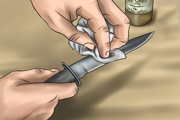 Image of a DIYer applying water displacing oil to a knife blade with a black oxide finish
