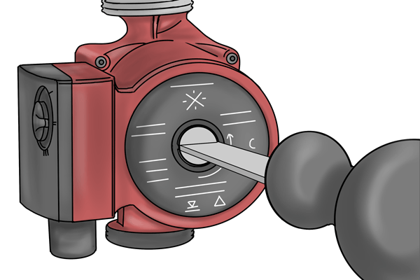 Image of a DIYer turning the impellor shaft inside a boiler pump with a screwdriver