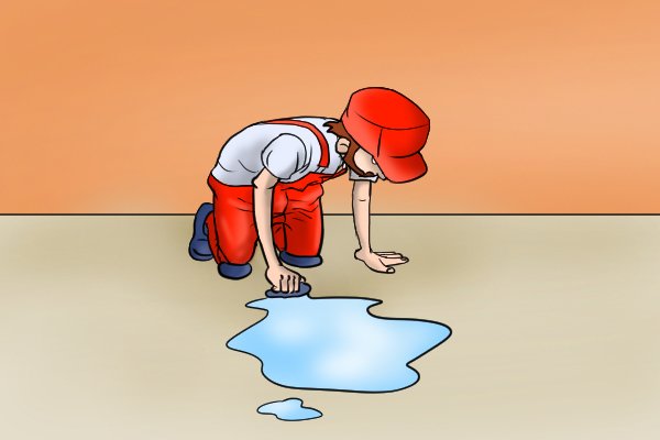 Image of a young, up and coming DIYer who is keenly mopping up the spillage from checking the impellor on their boiler pump