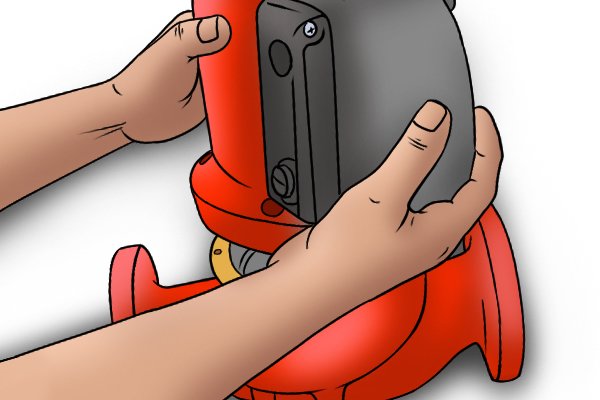 Image of a DIYer detaching the boiler pump head from the rest of the boiler pump assembly