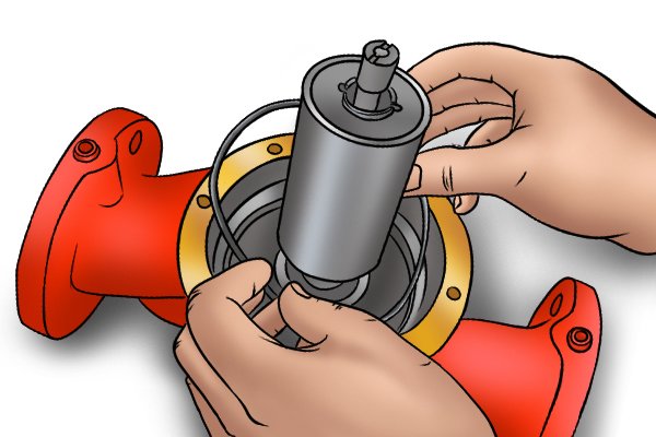 Image of a DIYer placing a new rubber gasket into a boiler pump volute