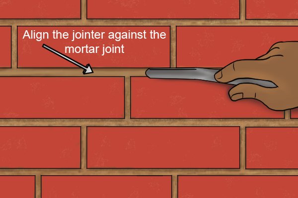 Align the jointer against the mortar joint
