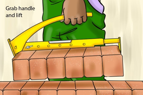 Finally once the both ends of the clamp are lined up, grab the handle securely with one hand and lift. This will cause the free end of the tongs to clamp the bricks against the fixed end. 