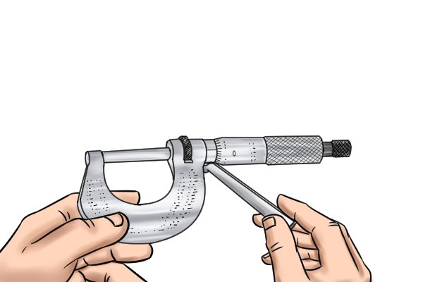 Although the sleeve of the micrometer is fixed tightly to the frame, it is not permanently attached.     Use the spanner wrench to turn the sleeve until the 0 aligns with the index line.