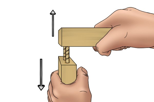 Image of a DIYer pulling a joint apart to check the angle of the dowel holes