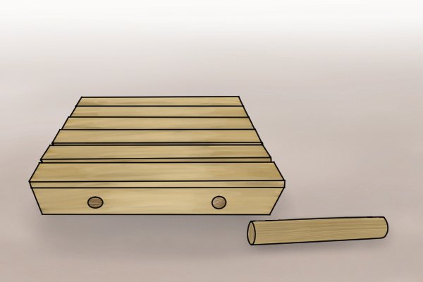 Brettstapel panel next to a dowel used for creating Brettstapel panels