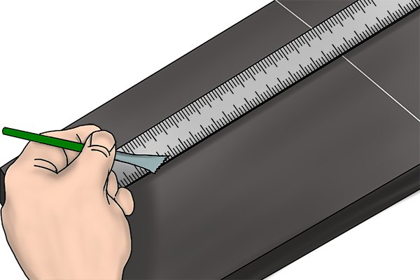 Using a ruler to mark end position of marking out line with a knife edge scriber