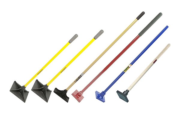 three earth rammers; wooden handled, metal handle and fibreglass handle