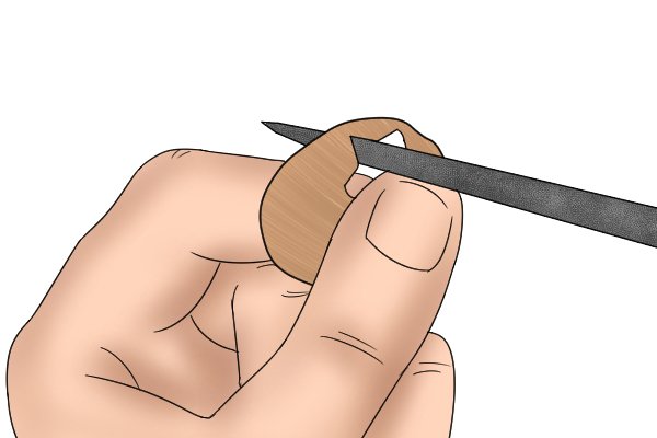 Image of a DIYer using a three square file to smooth the inside of a shape cut into a thin piece of wood