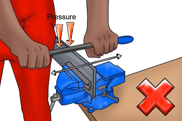 Image of a DIYer pressing hard enough to bend the file, which is a surefire way of causing chatter