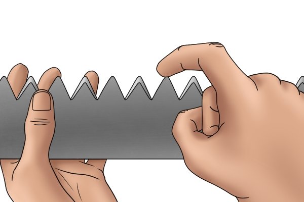 Image of a DIYer demonstrating the configuration of teeth on a cross cut saw