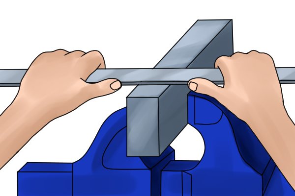 Image of a DIYer cross filing a piece of metal