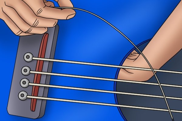 Image of a DIYer removing their guitar's strings so that they can dress the frets with a fret end dressing file