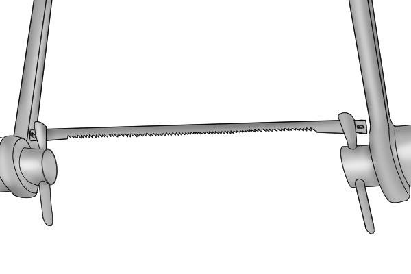 A coping saw has a removable blade mounted in a metal frame. 