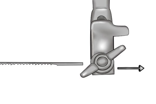 Loosening the wing nut causes a small clamp on the arm to open, releasing the blade.