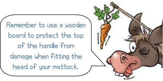 Wonkee donkee advice says "Don’t forget to use a wooden board to protect the handle when removing and replacing the head of your mattock."