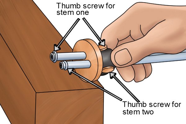 Labelled thumb screws of a wheel mortise marking gauge, each screw tightens or releases a different stem so they can be set to a mortise measurement