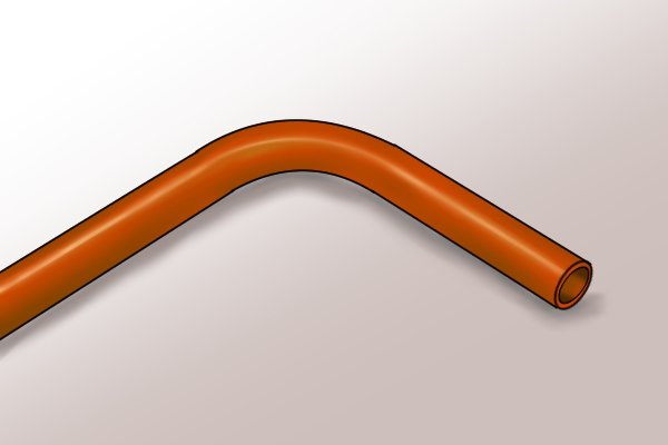 A piece of copper pipe that has been bent into a 90 degree bend using and ergo pipe bender