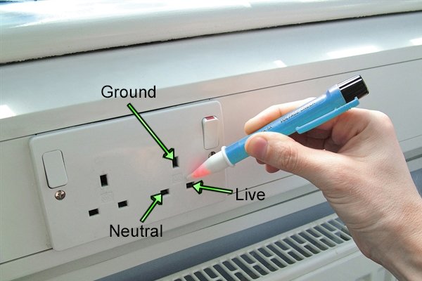 non-contact voltage detector in use on plug socket