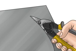Example of a pair of offset aviation snips in use to cut material.