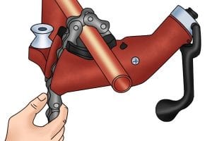 Tightening a chain pipe vice to secure the metal ready to be cut